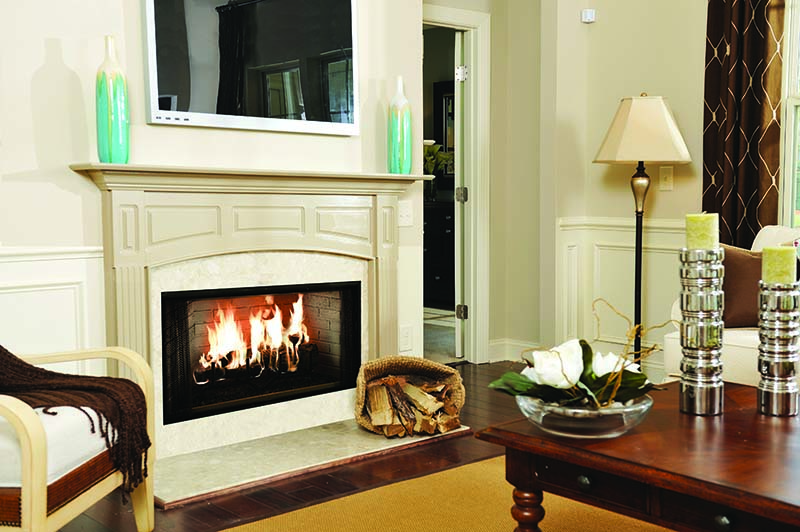A factory-built zero clearance wood fireplace with a white mantel in a living room A factory-built zero clearance wood fireplace with a white mantel in a living room