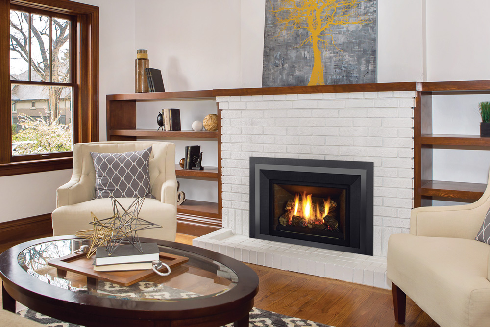 A Liberty Radiant gas insert burning in a white brick fireplace A Liberty Radiant gas insert burning in a white brick fireplace