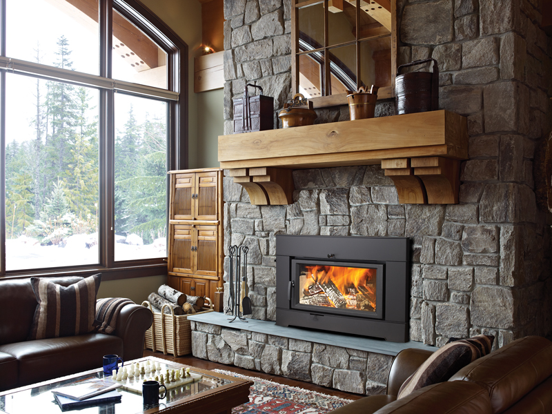 A Pro-Series wood insert with a linear firebox in a stone fireplace