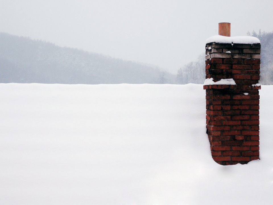 Roof and chimney covered in snow