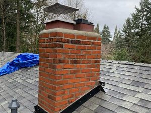 A brick chimney with fresh mortar joints after tuck-pointing